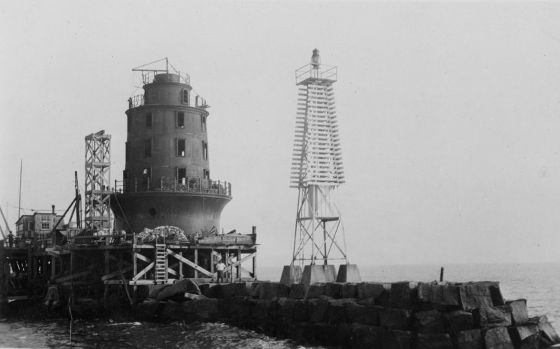The second Harbor of Refuge Light is under construction in 1926. A temporary beacon is shown standing next to the lighthouse. SOURCE: U.S. LIGHTHOUSE SERVICE